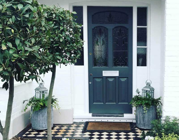 London doorway with vintage planters and lanterns